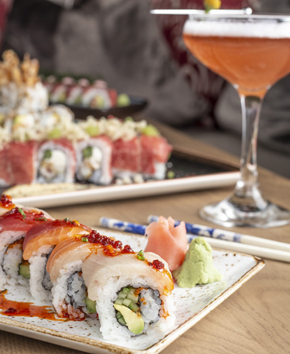 Sushi Roll plated with pink cocktail in champagne glass